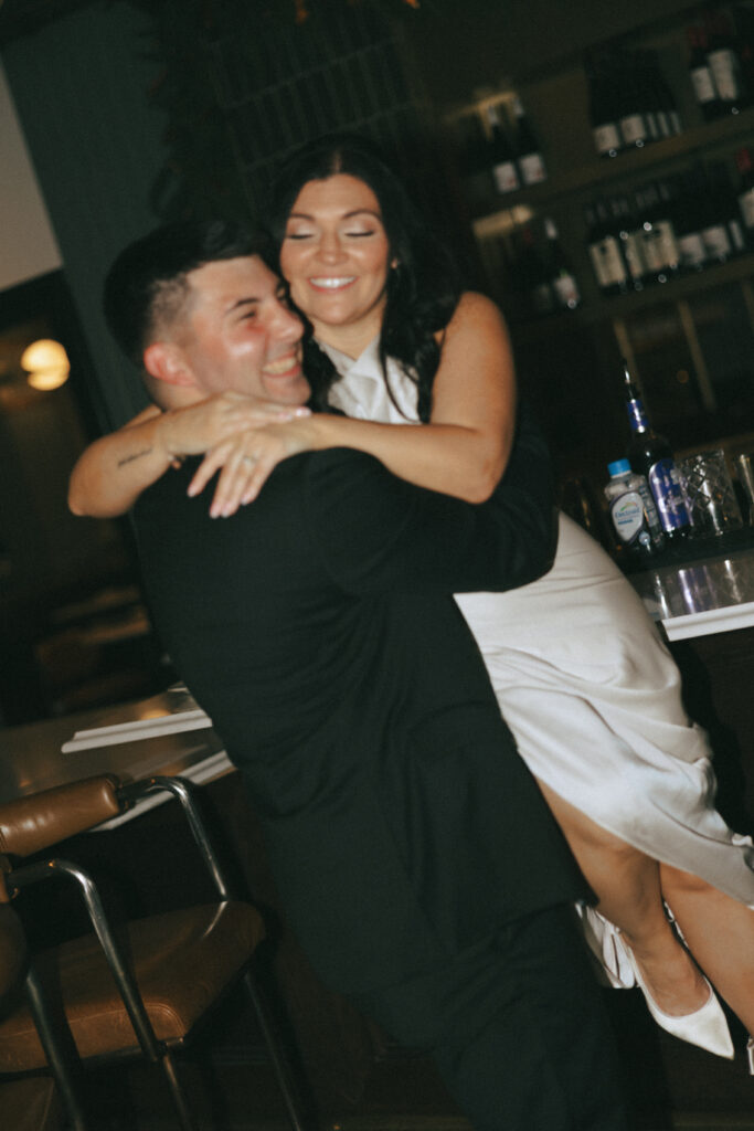 Couple standing at the bar in Hotel 1928, candid and relaxed.