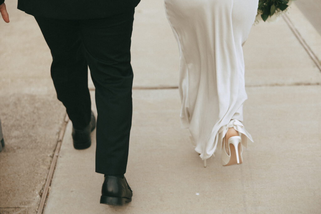 Bride and groom walking together in Waco, enjoying the city and moment.