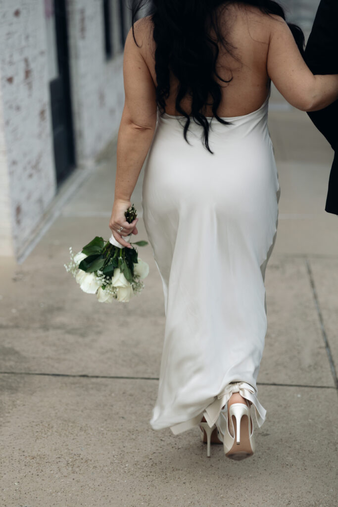 Bride and groom strolling through downtown Waco during their elopement day.