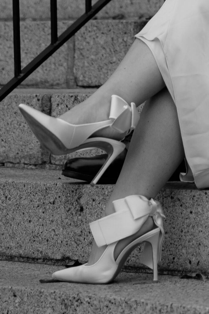 Close-up of bride's shoes in front of the historic courthouse.
