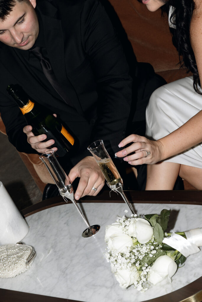 Close-up of champagne glasses in hotel room at Hotel 1928, ready for a toast.