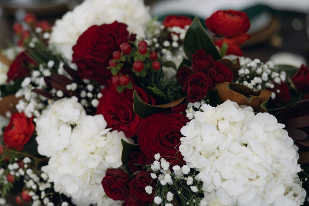Close-up of red and green florals at a Christmas wedding in Waco, Texas