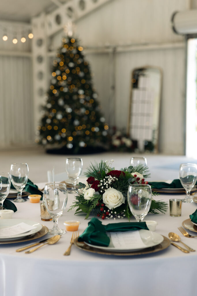 Holiday-inspired wedding table setting with candles and greenery in Waco, Texas