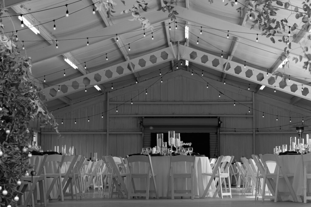 Wide angle black and white view of a candlelit wedding reception in Waco, Texas